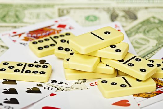 A handful of dominoes on a playing cards and money