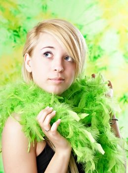 portrait of blond teen girl with green feather boa