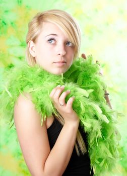 portrait of blond teen girl with green feather boa