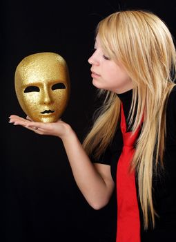 blond teen girl with gold mask, black background