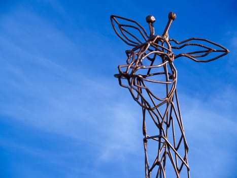 Metal statue sculpture of a giraffe modern street art