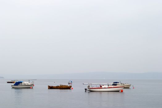 Oslo fjord with sail boats in the mist