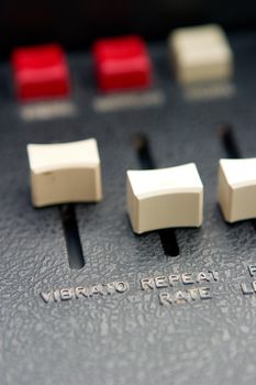 Retro organ slider details with focus on vibrato and repeat rate