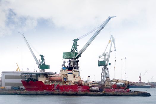 A large old transport ship being loaded.