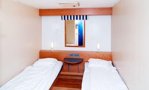 A very small cabin room on a cruise ship