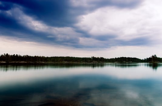 A dramatic image of a lake with vivid clouds