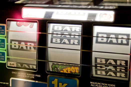 A detail image of a slot machine with the words BAR and Jackpot