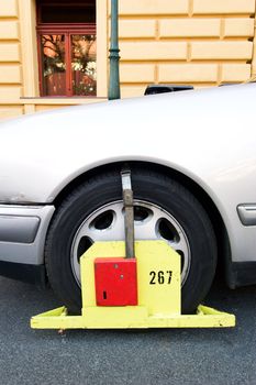 A wheel block 'parking ticket' in Prague, Czech Republic.