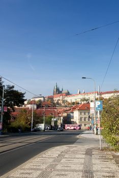 A street detail in prague with the castle in the background.