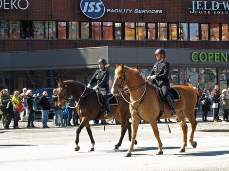 COPENHAGEN - APR 16:  Danish policewomen on horses patrols and secures the Copenhagen City Hall during the celebration of Queen Margrethe's 70th birthday on April 16, 2010.
