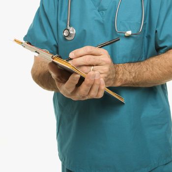 Mid-adult Caucasian male doctor taking notes on a patient's chart.