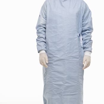 Mid-adult Caucasian male wearing scrubs and medical latex gloves.