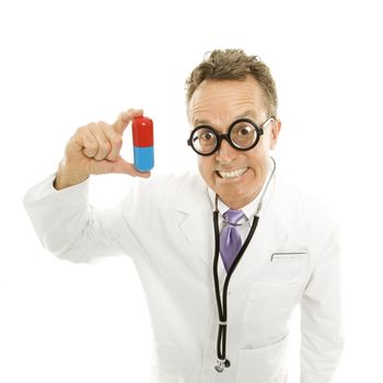 Mid-adult Caucasian male doctor wearing eyeglasses holding an oversized medical pill.