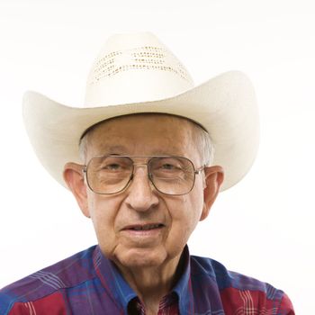 Portrait of Caucasion elderly man wearing plaid shirt and cowboy hat.