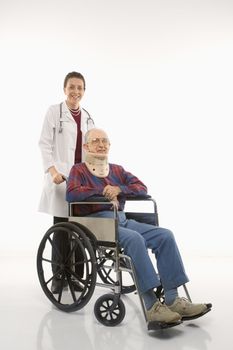 Mid-adult Caucasian female doctor pushing elderly Caucasian male with neck brace in wheelchair.