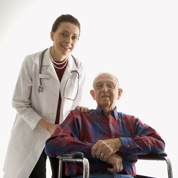 Mid-adult Caucasian female doctor with hands on elderly Caucasian male's shoulder in wheelchair.