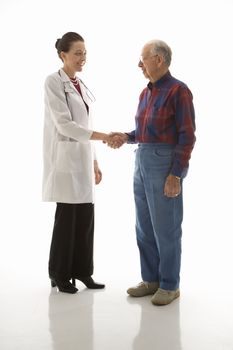 Mid-adult Caucasian female doctor shaking hands with an elderly Caucasian male.