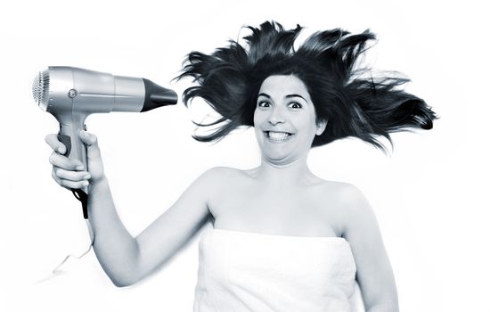 Young beautiful woman drying is hair