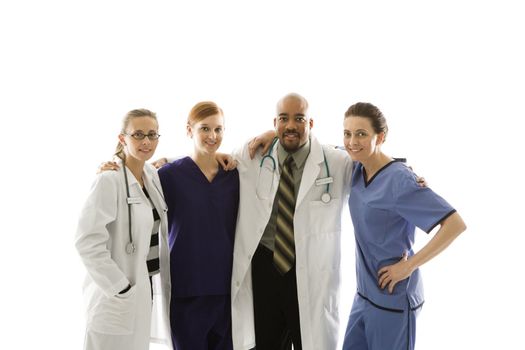 Half-length portrait of African-American man and Caucasian women medical healthcare workers in uniforms with arms around eachother standing against white background.