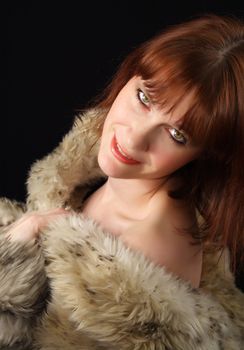 ginger-haired woman with factitious fur coat