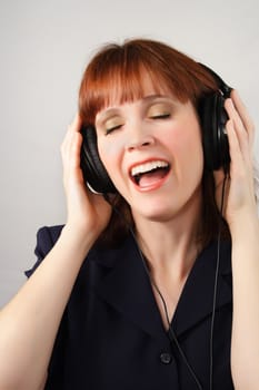 ginger-haired woman listening music 