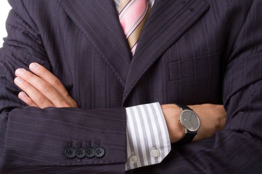 Arms across close up. Business man in suit.