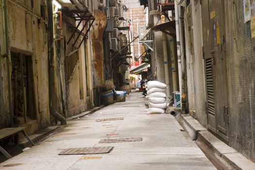 Looking down a long dark back alley

