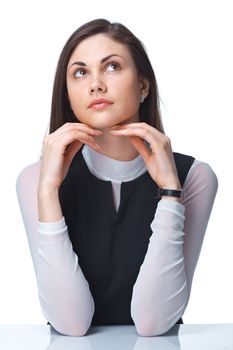 Closeup of a thoughtful young woman looking up over white background 