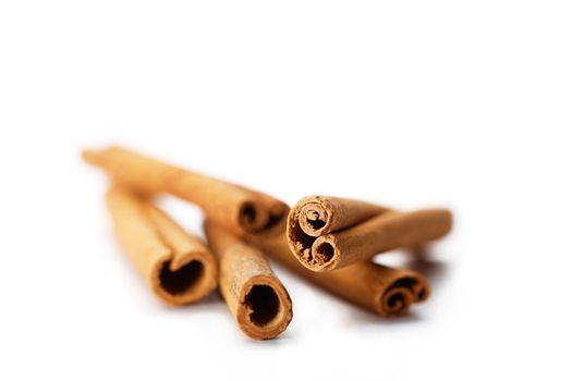 Five cinnamon sticks on white background