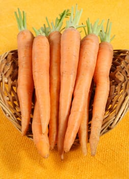 fresh carrots in a wicker basket