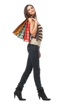 Full length portrait of a young woman with bags over white