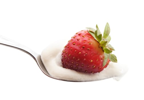 fresh whipped cream and strawberry on a spoon