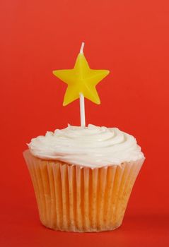 homemade cupcakes with icing and star candle