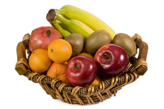 variety of fresh fruit on basket isolated on white