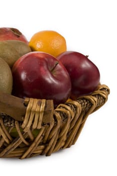 variety of fresh fruit on basket isolated on white