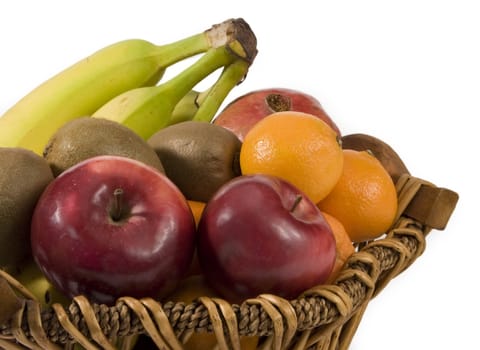 variety of fresh fruit on basket isolated on white
