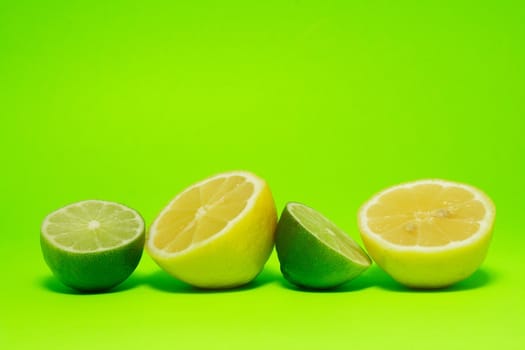fresh lemon and lime on green background