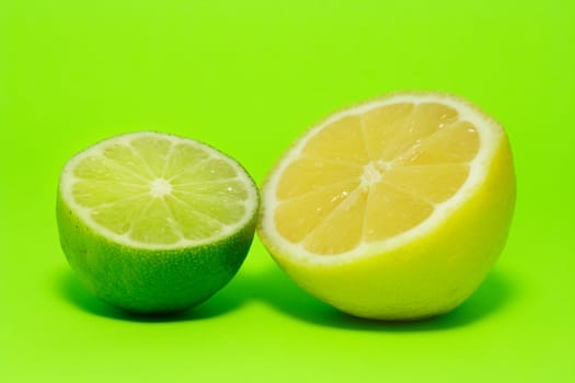 fresh lemon and lime on green background