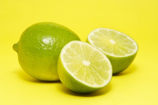 fresh lime on yellow background