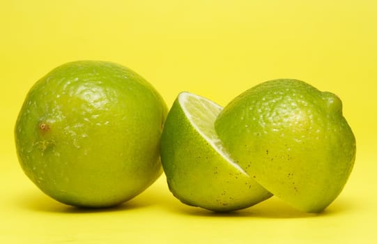 fresh lime on yellow background