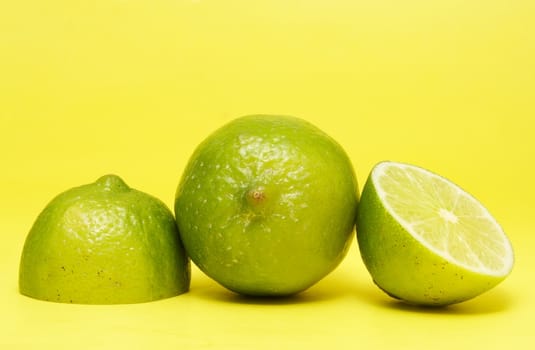 fresh lime on yellow background