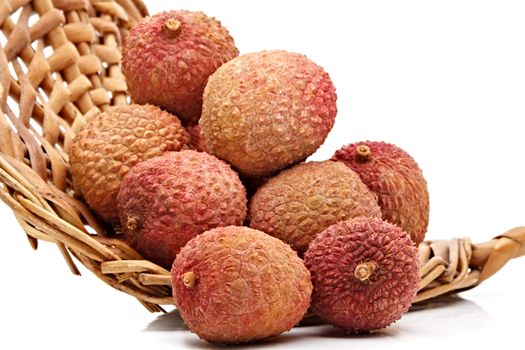 some fresh whole ripe lichees on a wicker basket