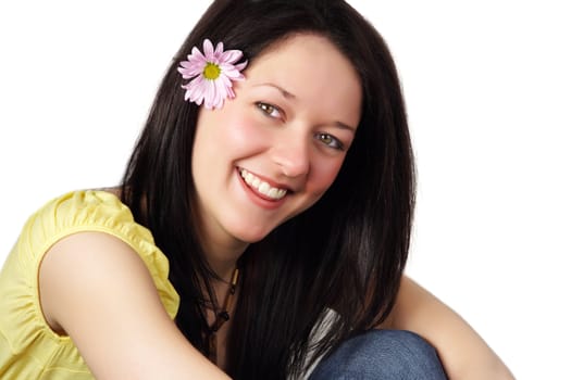 young woman with a nice smile and daisy flower on her hair, isolated on white