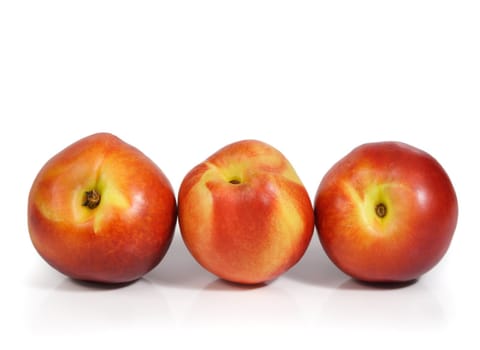 three nectarines isolated on white background