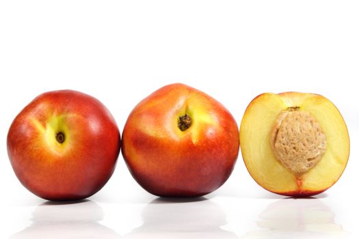 three nectarines isolated on white background