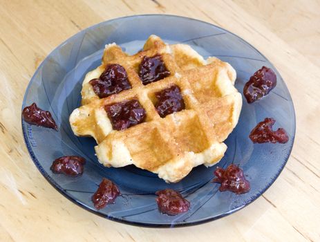 homemade waffle with cherry jam