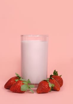 glass of strawberry milk with fresh fruit