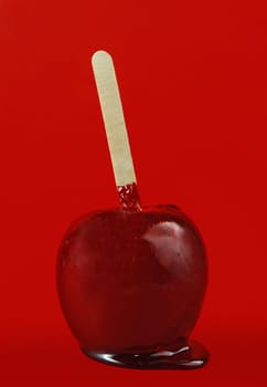red candy apple on red background
