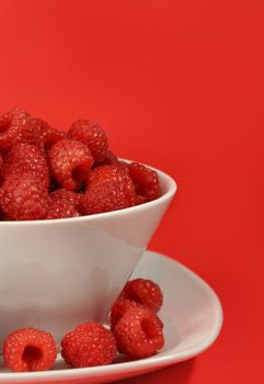 bunch of fresh raspberries on white bowl