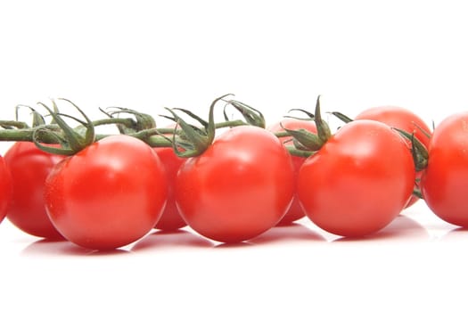 cluster of small tomatoes isolated on white